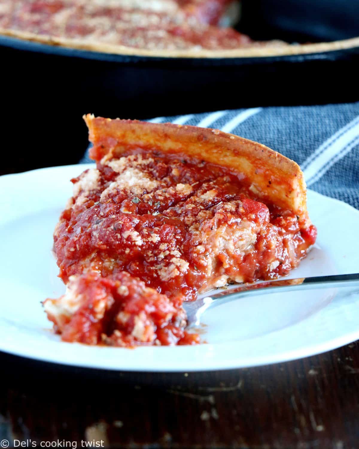 Discover the authentic Chicago-style deep dish pizza, made with a crunchy flaky crust and garnished with thick layers of cheese and tomato sauce.