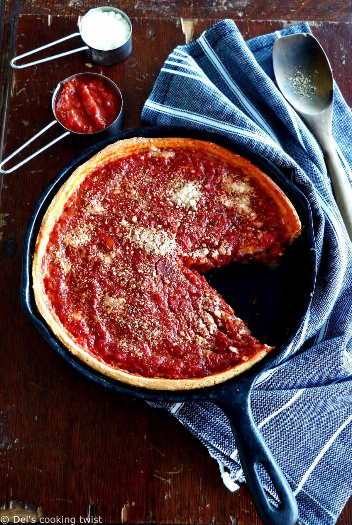 Discover the authentic Chicago-style deep dish pizza, made with a crunchy flaky crust and garnished with thick layers of cheese and tomato sauce.