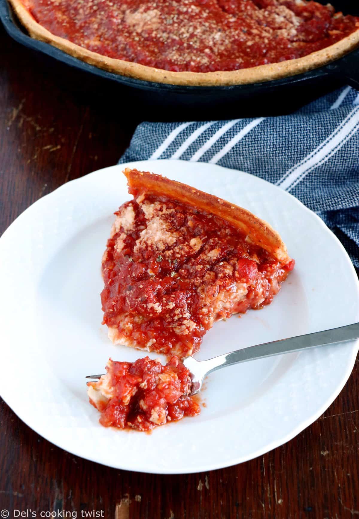 Discover the authentic Chicago-style deep dish pizza, made with a crunchy flaky crust and garnished with thick layers of cheese and tomato sauce.