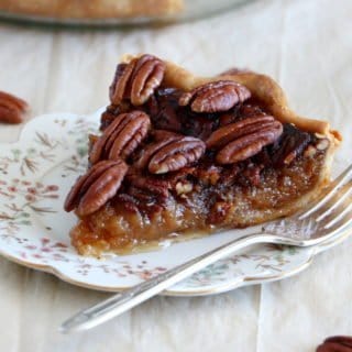 Here's the BEST pecan pie recipe. This old-fashioned dessert features a sweet, gooey center, and crunchy pecans. Perfect for the holidays!