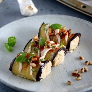 Eggplant rolls filled with a homemade roasted garlic hummus make a fantastic healthy appetizer or snack, that is also vegan and gluten-free.