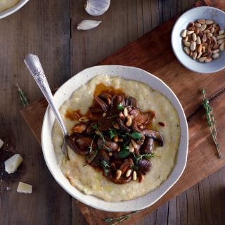 Parmesan polenta with thyme mushroom ragu makes a hearty plant-based dinner recipe for those chilly days. Enjoy with a glass of wine!