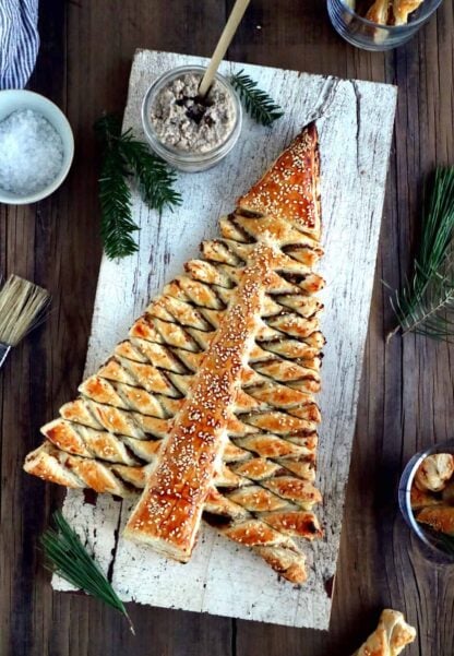 Puff pastry Christmas tree is a festive holiday appetizer with pull-apart breadsticks filled with savory toppings of your choice. Easy to make and delicious, it is sure to impress at your next Christmas party!