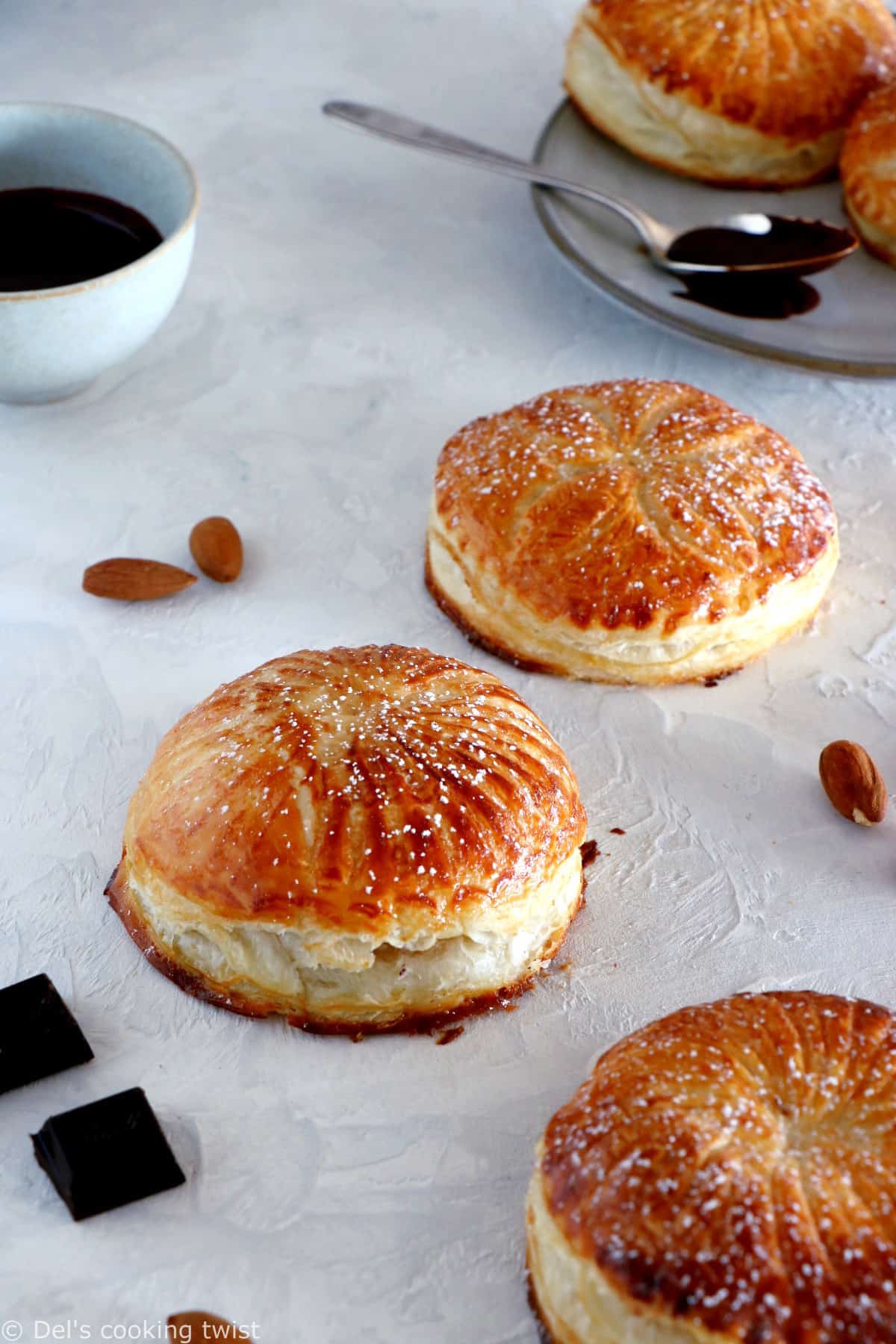 These mini galettes des rois are a rich almond paste and puff pastry confection which commemorates the Epiphany. Add a twist of chocolate and pears, and it becomes the most delightful dessert.