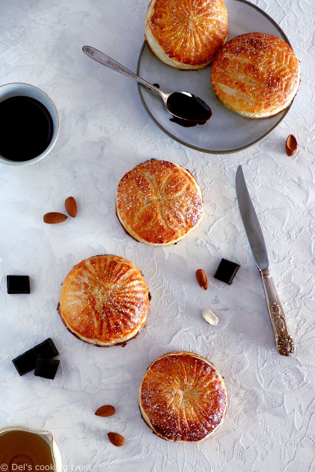 These mini galettes des rois are a rich almond paste and puff pastry confection which commemorates the Epiphany. Add a twist of chocolate and pears, and it becomes the most delightful dessert.