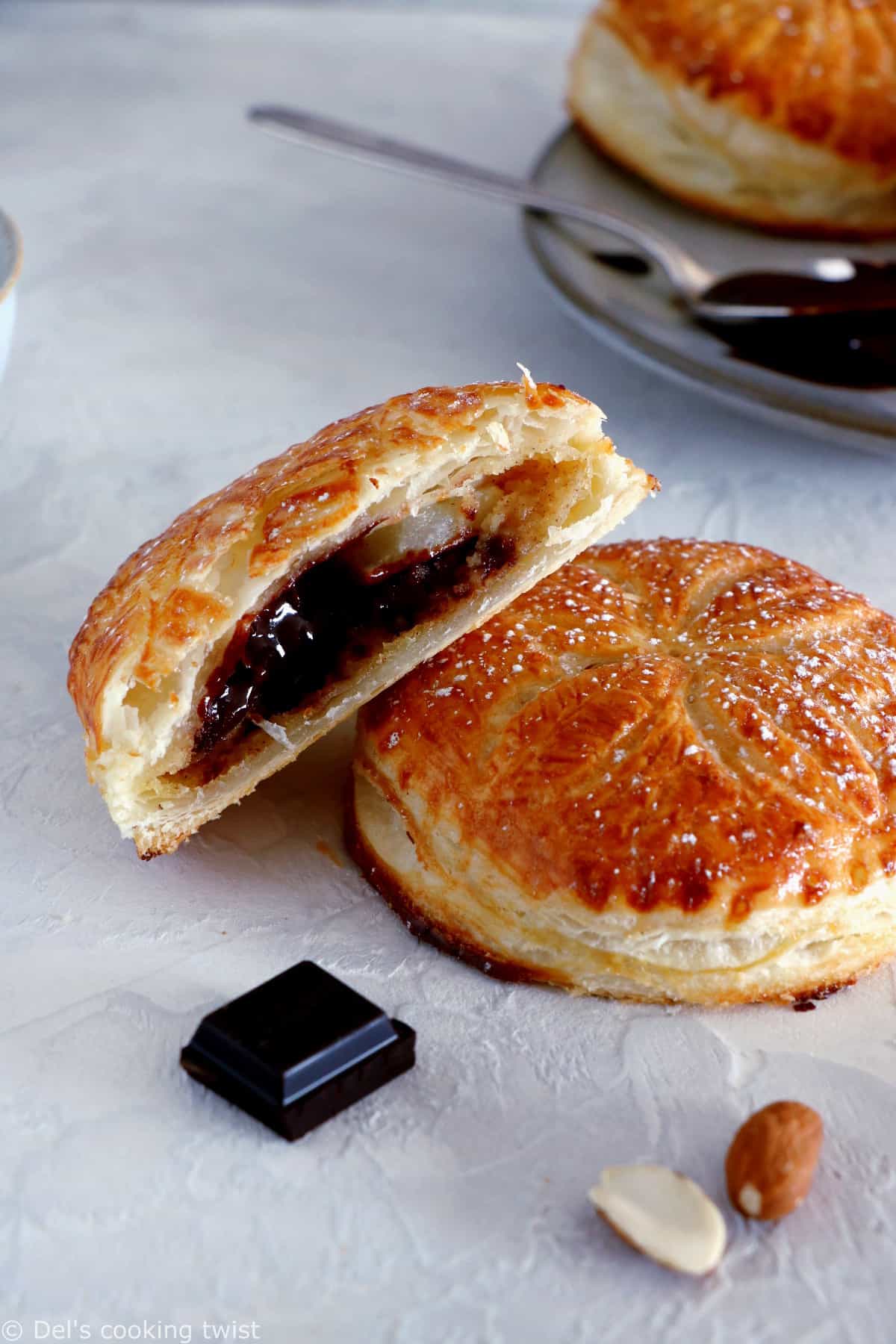 These mini galettes des rois are a rich almond paste and puff pastry confection which commemorates the Epiphany. Add a twist of chocolate and pears, and it becomes the most delightful dessert.