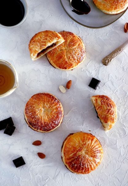 These mini galettes des rois are a rich almond paste and puff pastry confection which commemorates the Epiphany. Add a twist of chocolate and pears, and it becomes the most delightful dessert.