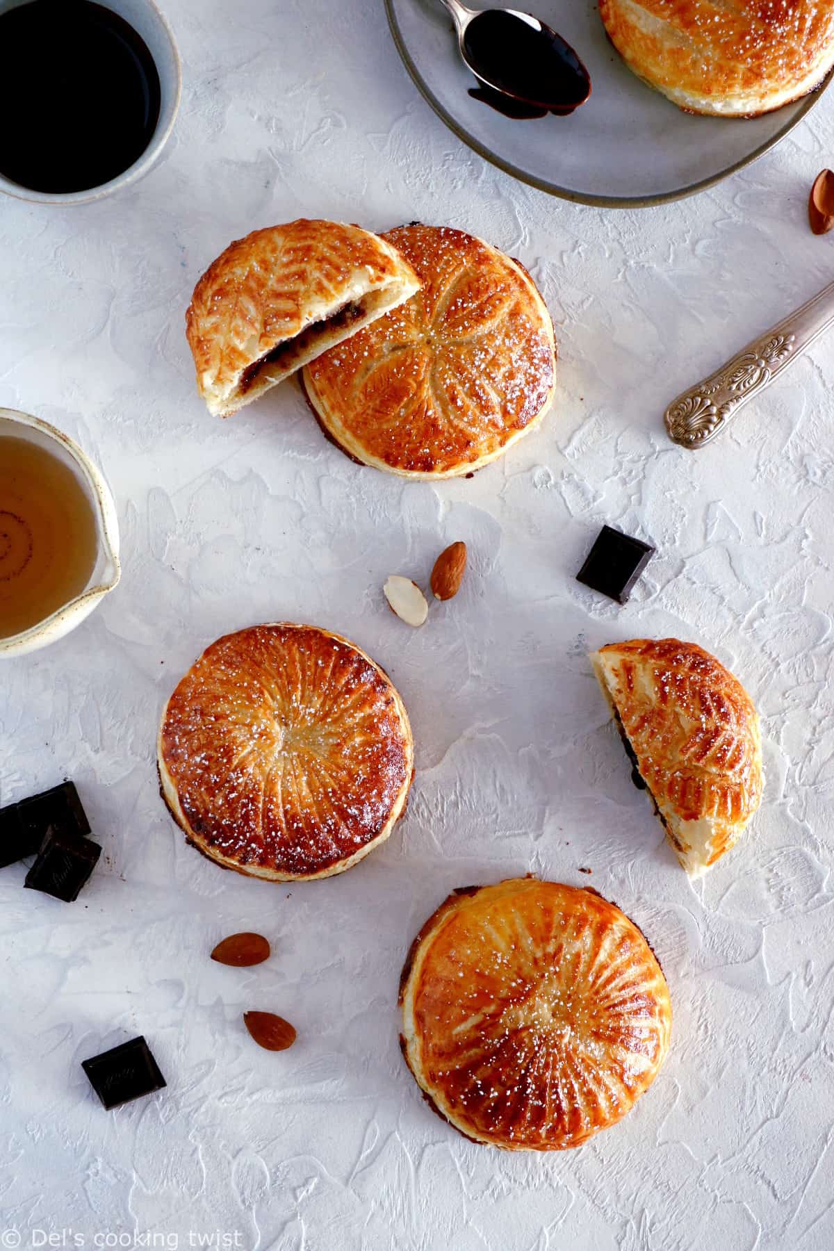 These mini galettes des rois are a rich almond paste and puff pastry confection which commemorates the Epiphany. Add a twist of chocolate and pears, and it becomes the most delightful dessert.