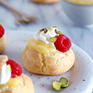 Easy raspberry and lemon curd cream puffs make a delicious fancy sweet dessert with a lovely touch of acidity brought by the homemade lemon curd and the fresh raspberries.