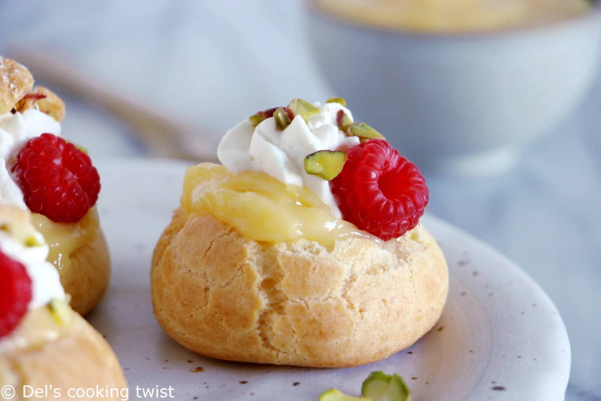 Easy raspberry and lemon curd cream puffs make a delicious fancy sweet dessert with a lovely touch of acidity brought by the homemade lemon curd and the fresh raspberries.