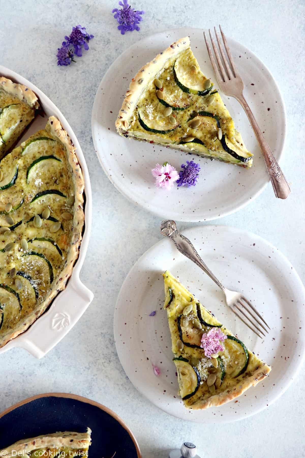 This delicious zucchini quiche features fresh goat cheese, pesto, and a subtle pie crust with seeds.