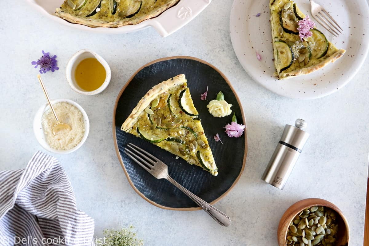 This delicious zucchini quiche features fresh goat cheese, pesto, and a subtle pie crust with seeds.