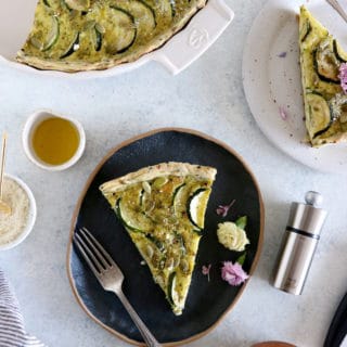 This delicious zucchini quiche features fresh goat cheese, pesto, and a subtle pie crust with seeds.