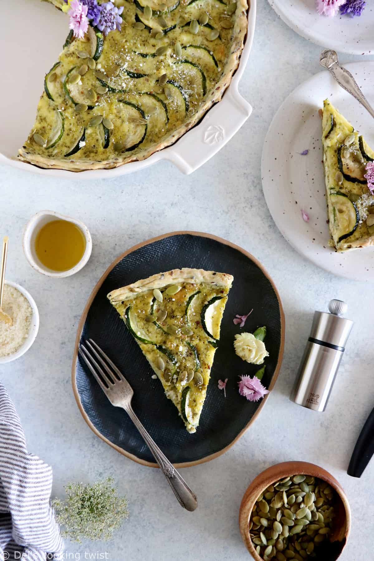 This delicious zucchini quiche features fresh goat cheese, pesto, and a subtle pie crust with seeds.