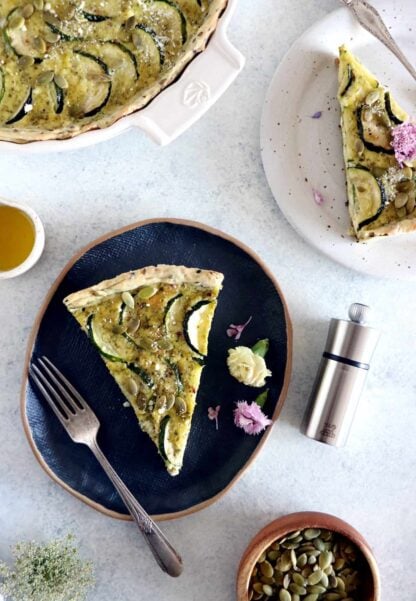 This delicious zucchini quiche features fresh goat cheese, pesto, and a subtle pie crust with seeds.