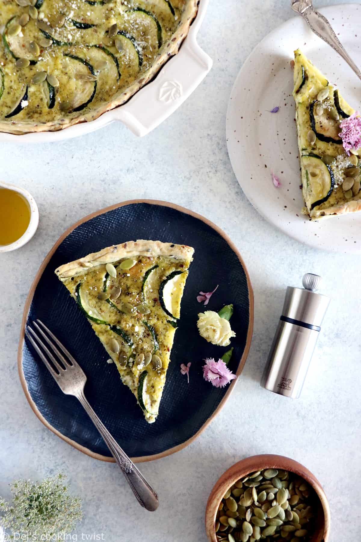 This delicious zucchini quiche features fresh goat cheese, pesto, and a subtle pie crust with seeds.