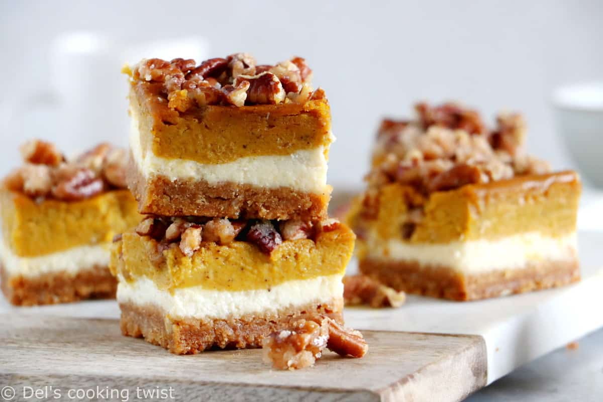 These amazing pumpkin cheesecake bars with candied pecans are delicious and so EASY to make! Full of fall spices, the 4 layers come easily together in a sumptuous dessert that is sure to impress at any holiday gathering.