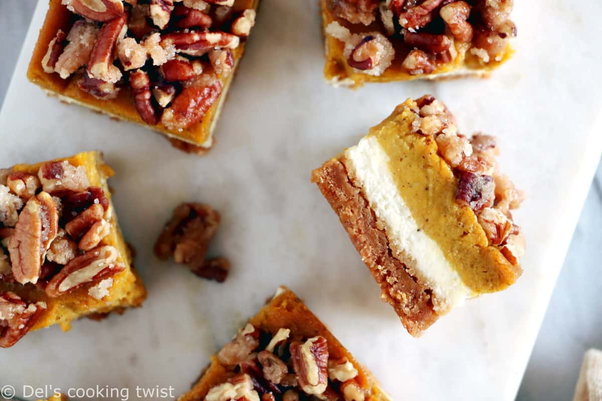 These amazing pumpkin cheesecake bars with candied pecans are delicious and so EASY to make! Full of fall spices, the 4 layers come easily together in a sumptuous dessert that is sure to impress at any holiday gathering.