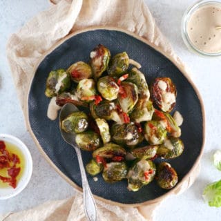 Soy roasted Brussels sprouts with cashew sauce are crispy, tender, with a subtle Asian touch.