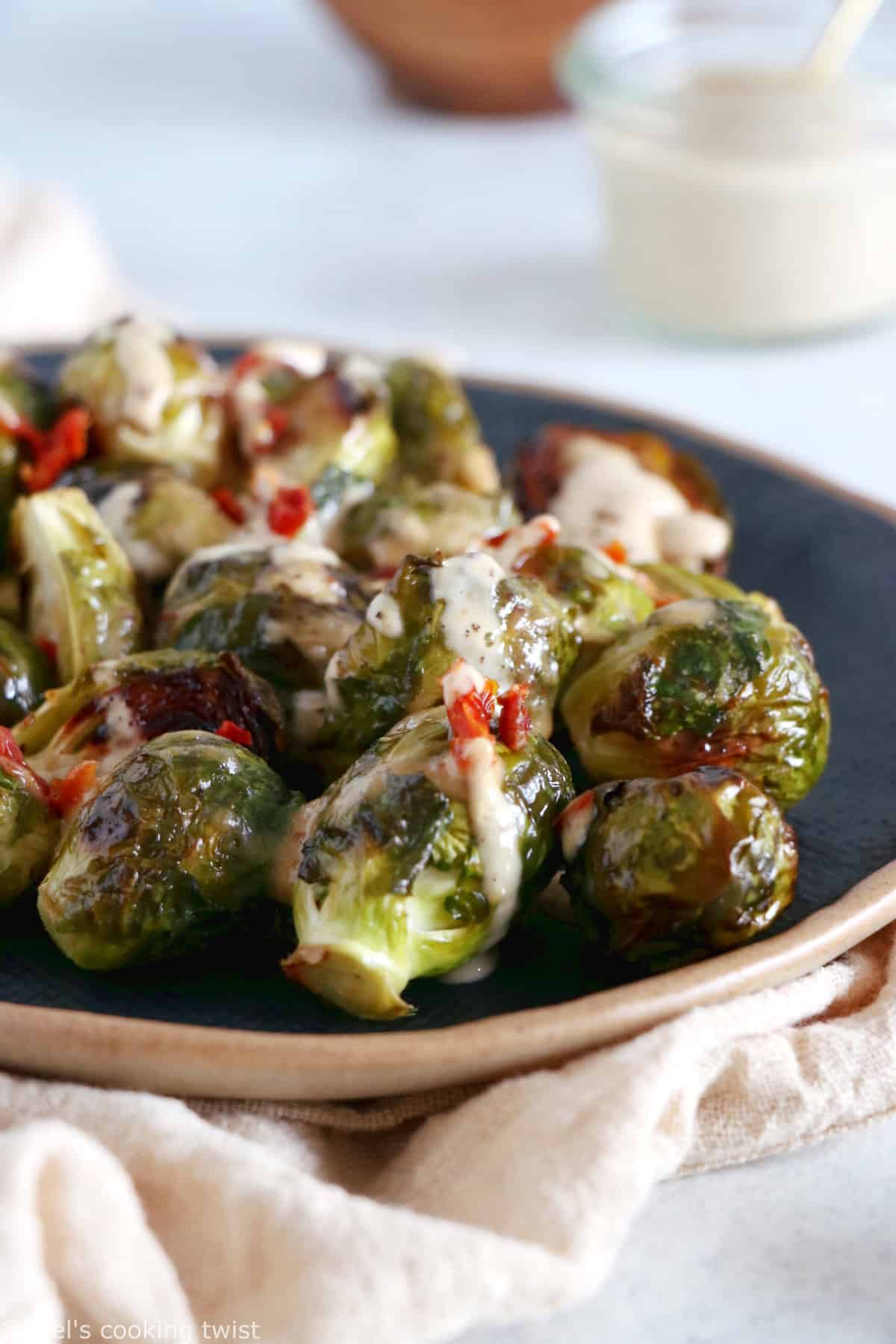 Soy roasted Brussels sprouts with cashew sauce are crispy, tender, with a subtle Asian touch.