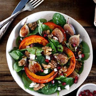 This roasted squash salad features caramelized figs with balsamic vinegar, baby spinach, and a subtle shallot vinaigrette.