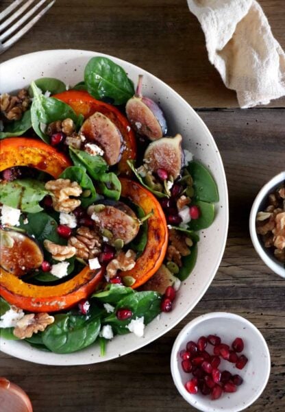 This roasted squash salad features caramelized figs with balsamic vinegar, baby spinach, and a subtle shallot vinaigrette.