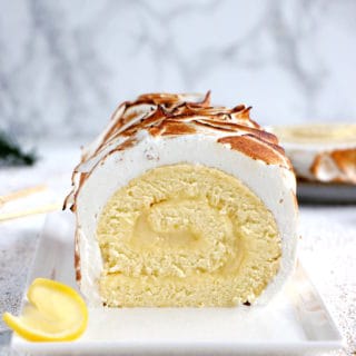 Lemon Meringue Roulade or cake roll consists of a supremely moist sponge cake filled with homemade lemon curd and covered with swirls of torched meringue.