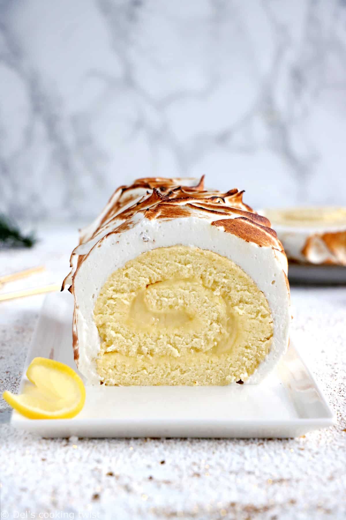 Lemon Meringue Roulade or cake roll consists of a supremely moist sponge cake filled with homemade lemon curd and covered with swirls of torched meringue.