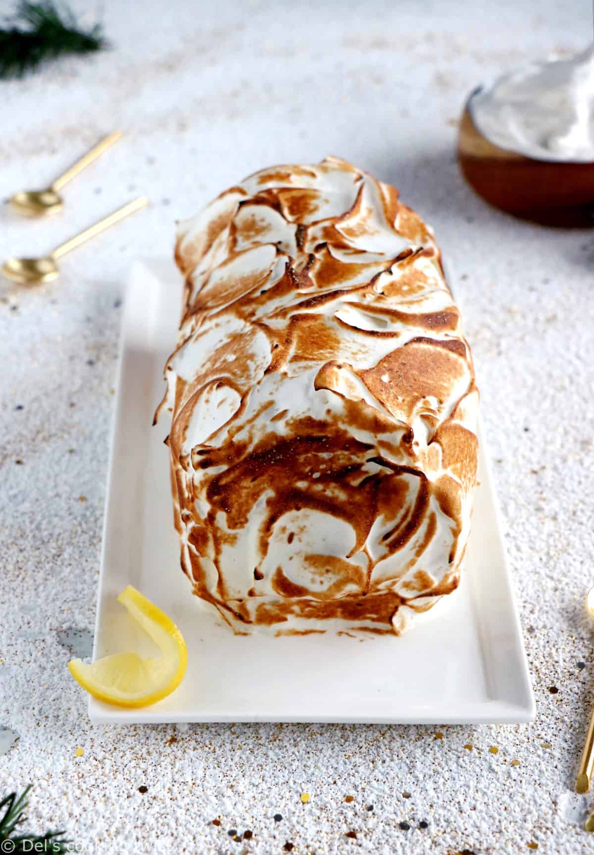 Lemon Meringue Roulade or cake roll consists of a supremely moist sponge cake filled with homemade lemon curd and covered with swirls of torched meringue.