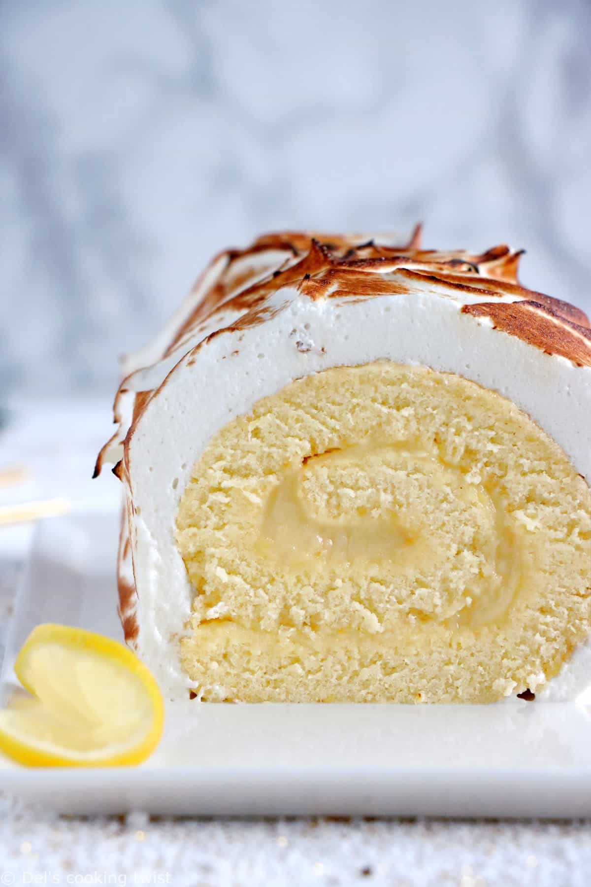 Lemon Meringue Roulade or cake roll consists of a supremely moist sponge cake filled with homemade lemon curd and covered with swirls of torched meringue.