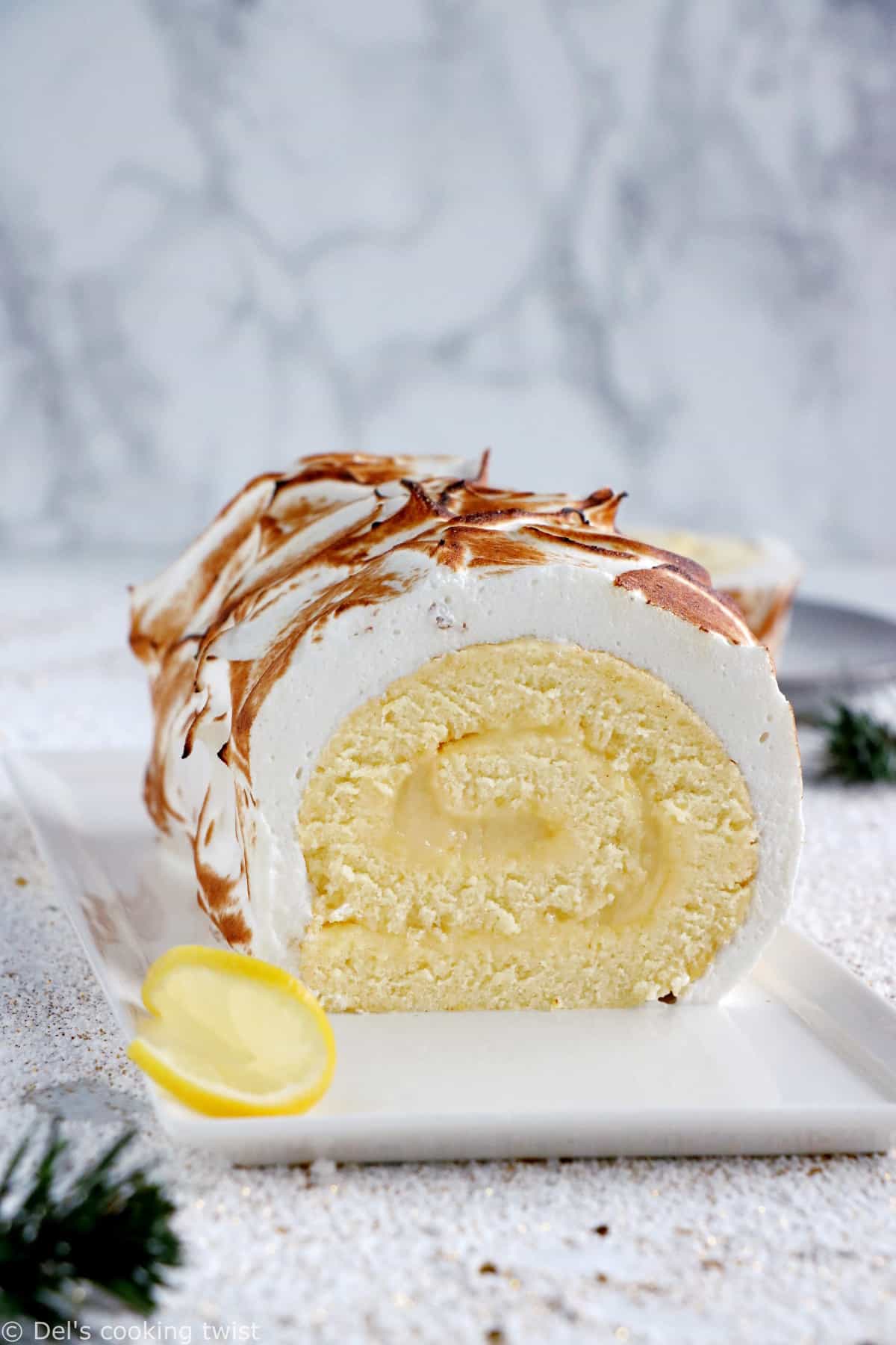 Lemon Meringue Roulade or cake roll consists of a supremely moist sponge cake filled with homemade lemon curd and covered with swirls of torched meringue.