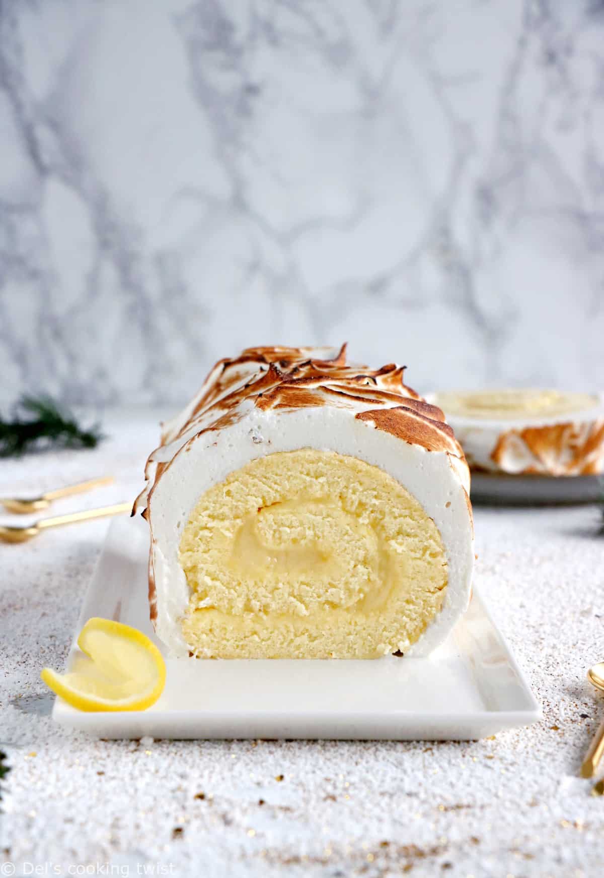 Lemon Meringue Roulade or cake roll consists of a supremely moist sponge cake filled with homemade lemon curd and covered with swirls of torched meringue.