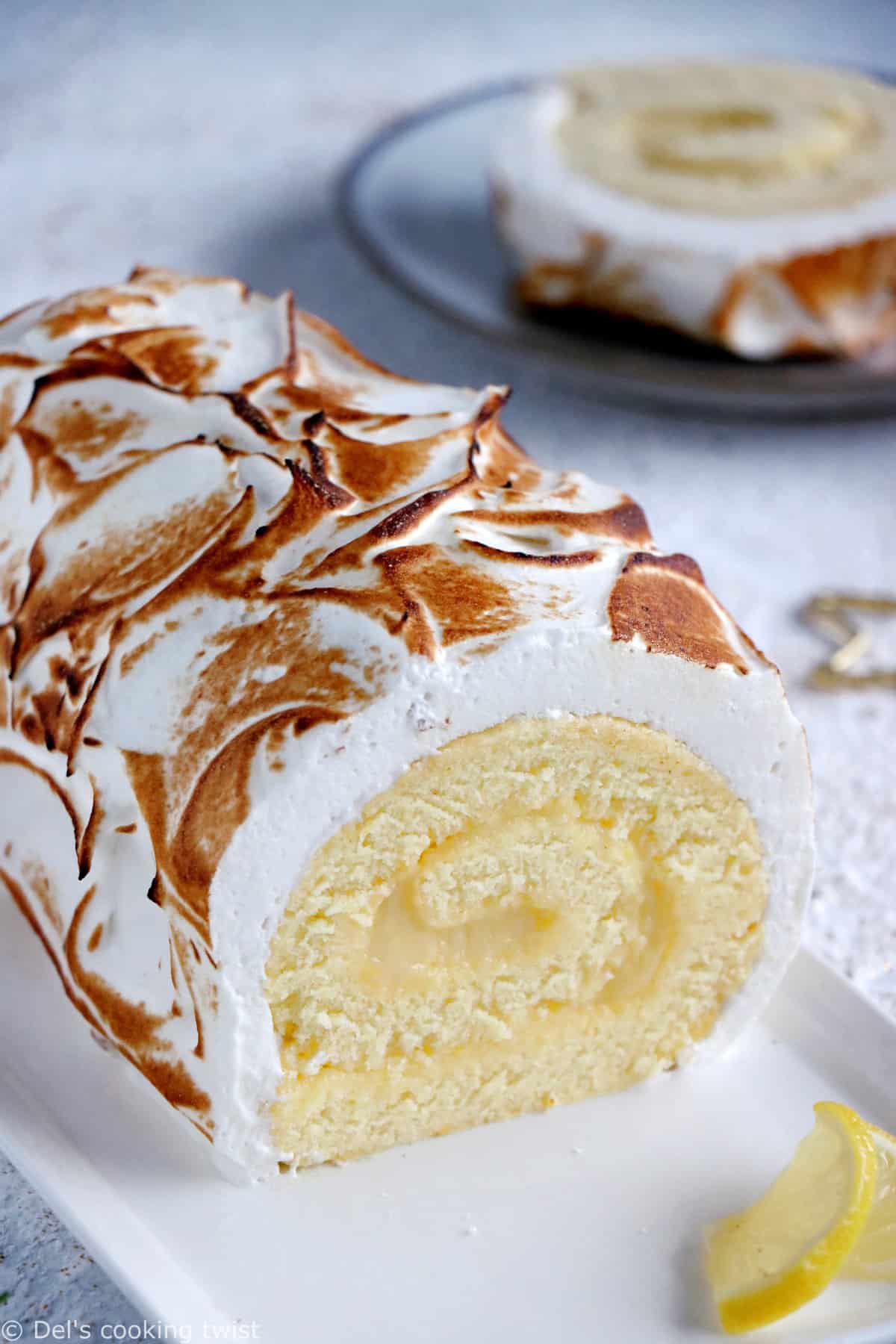 Lemon Meringue Roulade or cake roll consists of a supremely moist sponge cake filled with homemade lemon curd and covered with swirls of torched meringue.