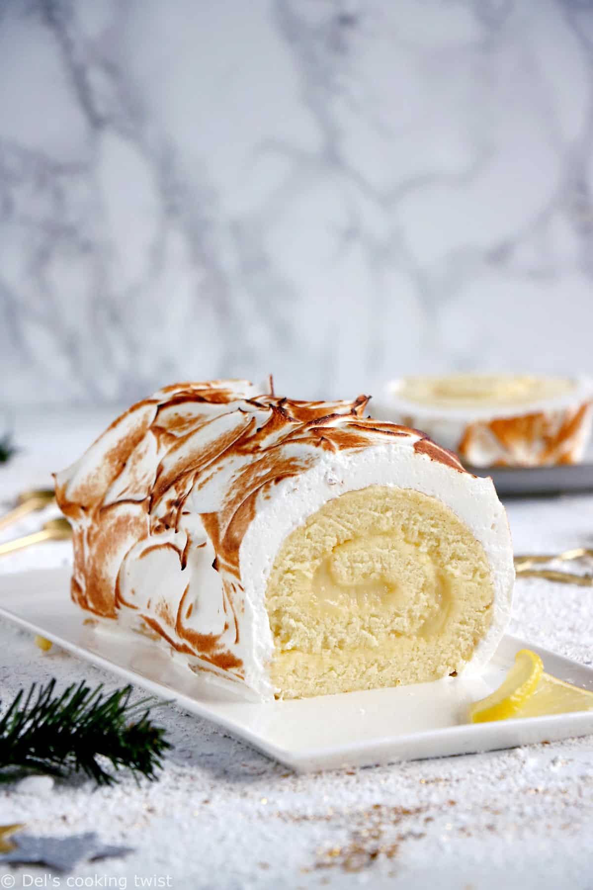 Lemon Meringue Roulade or cake roll consists of a supremely moist sponge cake filled with homemade lemon curd and covered with swirls of torched meringue.