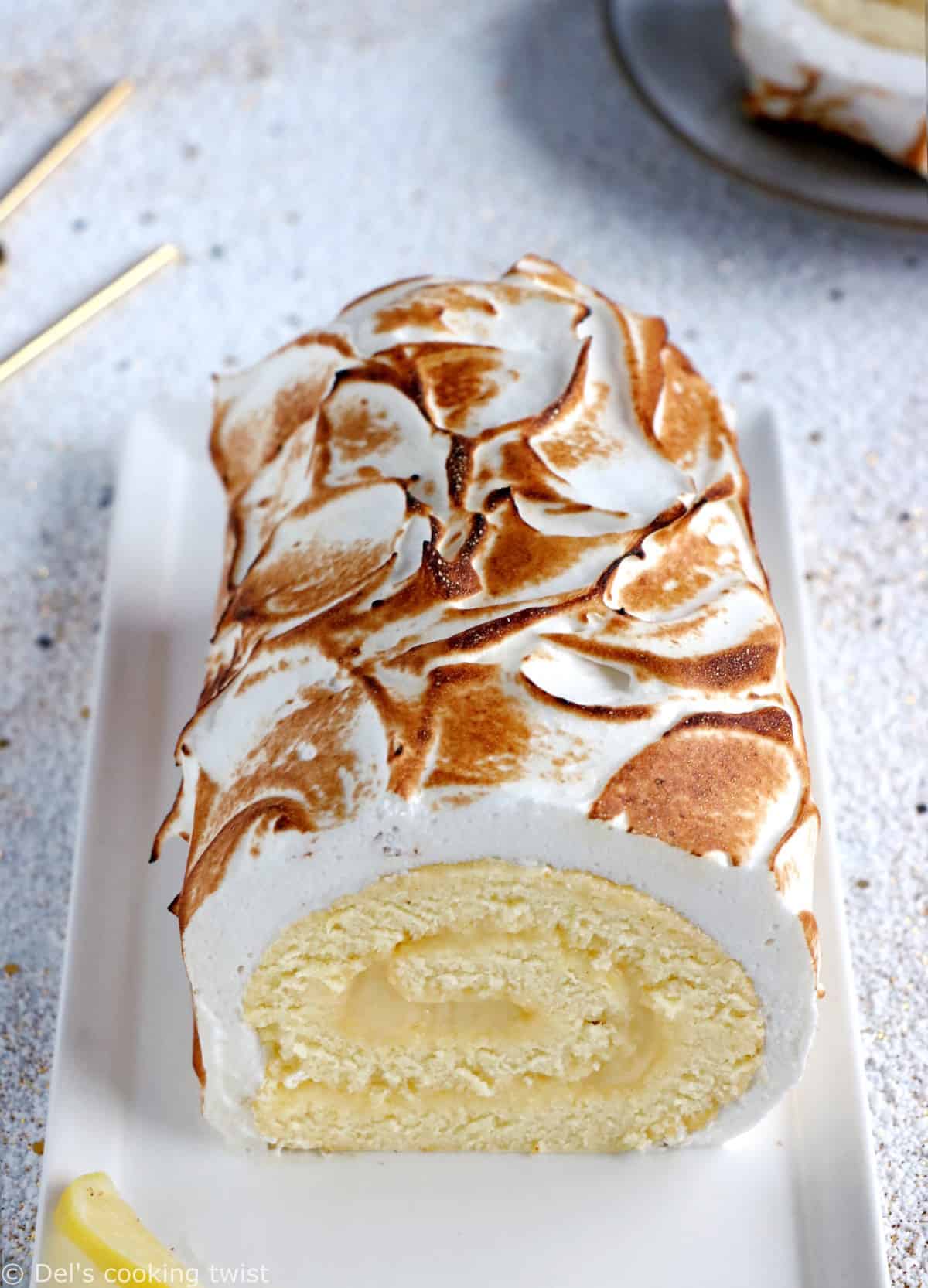 Lemon Meringue Roulade or cake roll consists of a supremely moist sponge cake filled with homemade lemon curd and covered with swirls of torched meringue.