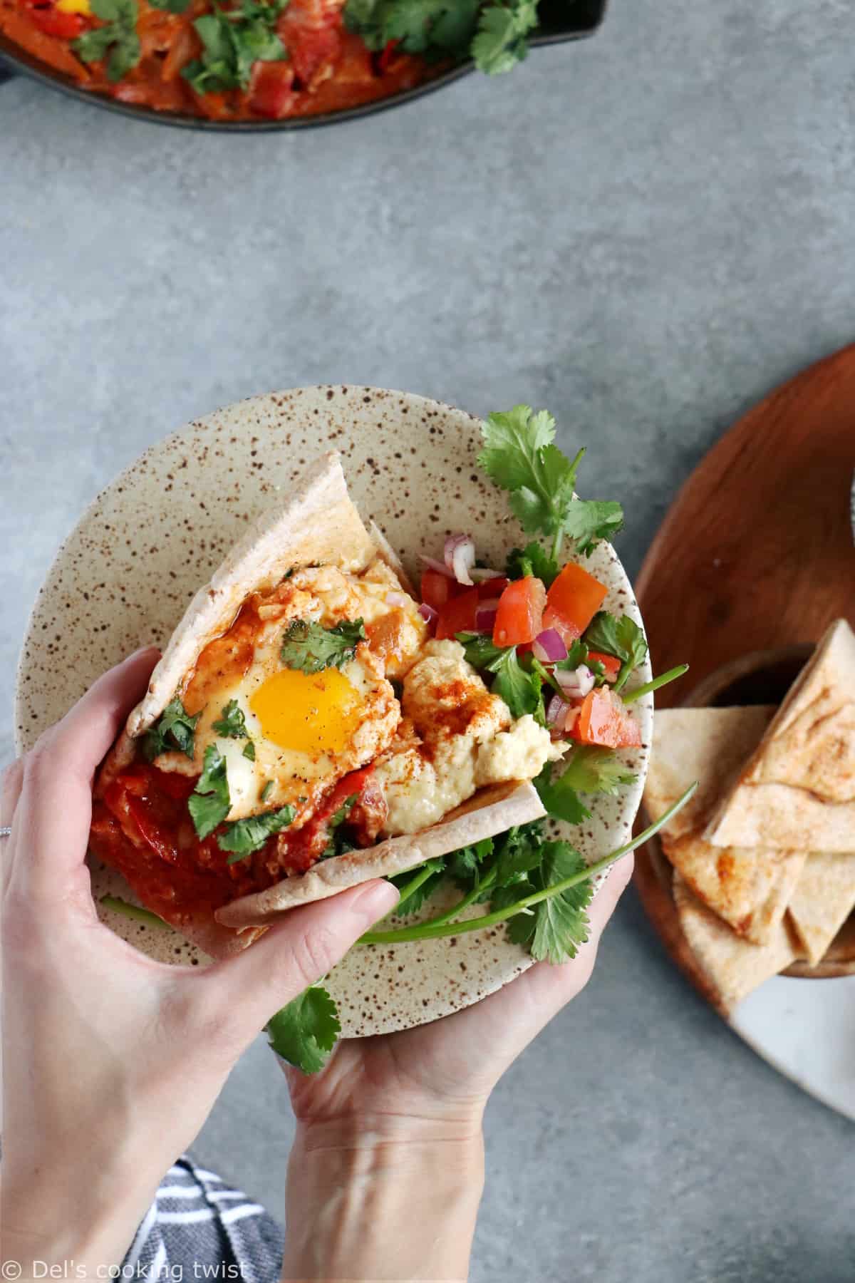 Ever wondered how to serve a shakshuka? Place it in the center of the table and serve with various small plates, breads and salads to make this meal a feast!