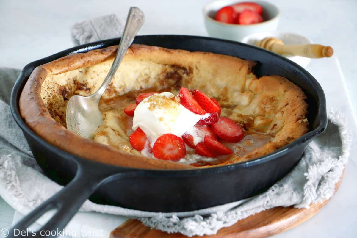EASY brown butter Dutch Baby pancake with strawberries. It all happens in one pan, it's convivial and packed with delicious flavors of brown butter and cinnamon.
