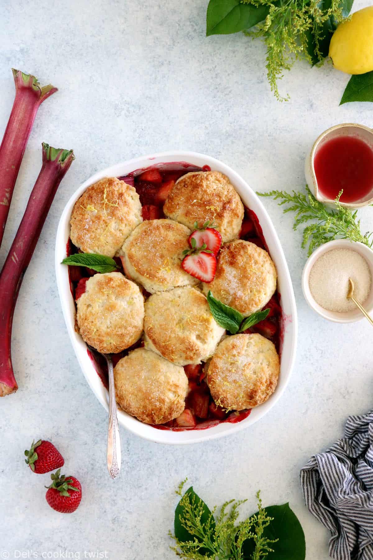 This rhubarb, strawberry, apple cobbler features a sweet and tangy fruity filling topped with some flaky dropped biscuits.
