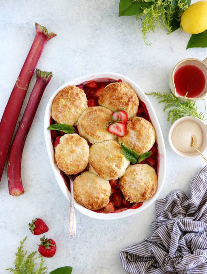 This rhubarb, strawberry, apple cobbler features a sweet and tangy fruity filling topped with some flaky dropped biscuits.