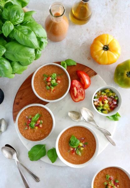 Cool off with this easy 10-minute gazpacho recipe. Prepared with sun-ripe tomatoes and other summer vegetables mixed in a blender with other seasoning, this chilled soup is super refreshing and bursting with fresh-from-the-garden flavors.