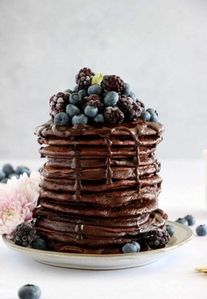 Perfect chocolate pancakes are easy to make, fluffy, and topped with a rich hot chocolate sauce.