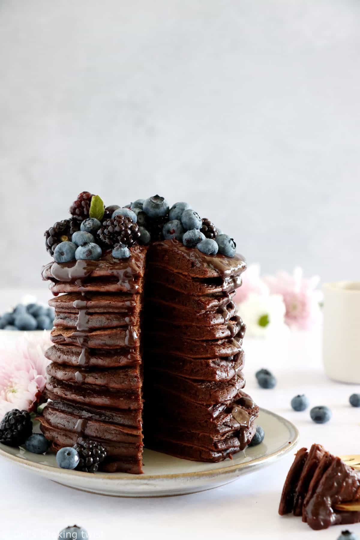 Perfect chocolate pancakes are easy to make, fluffy, and topped with a rich hot chocolate sauce.