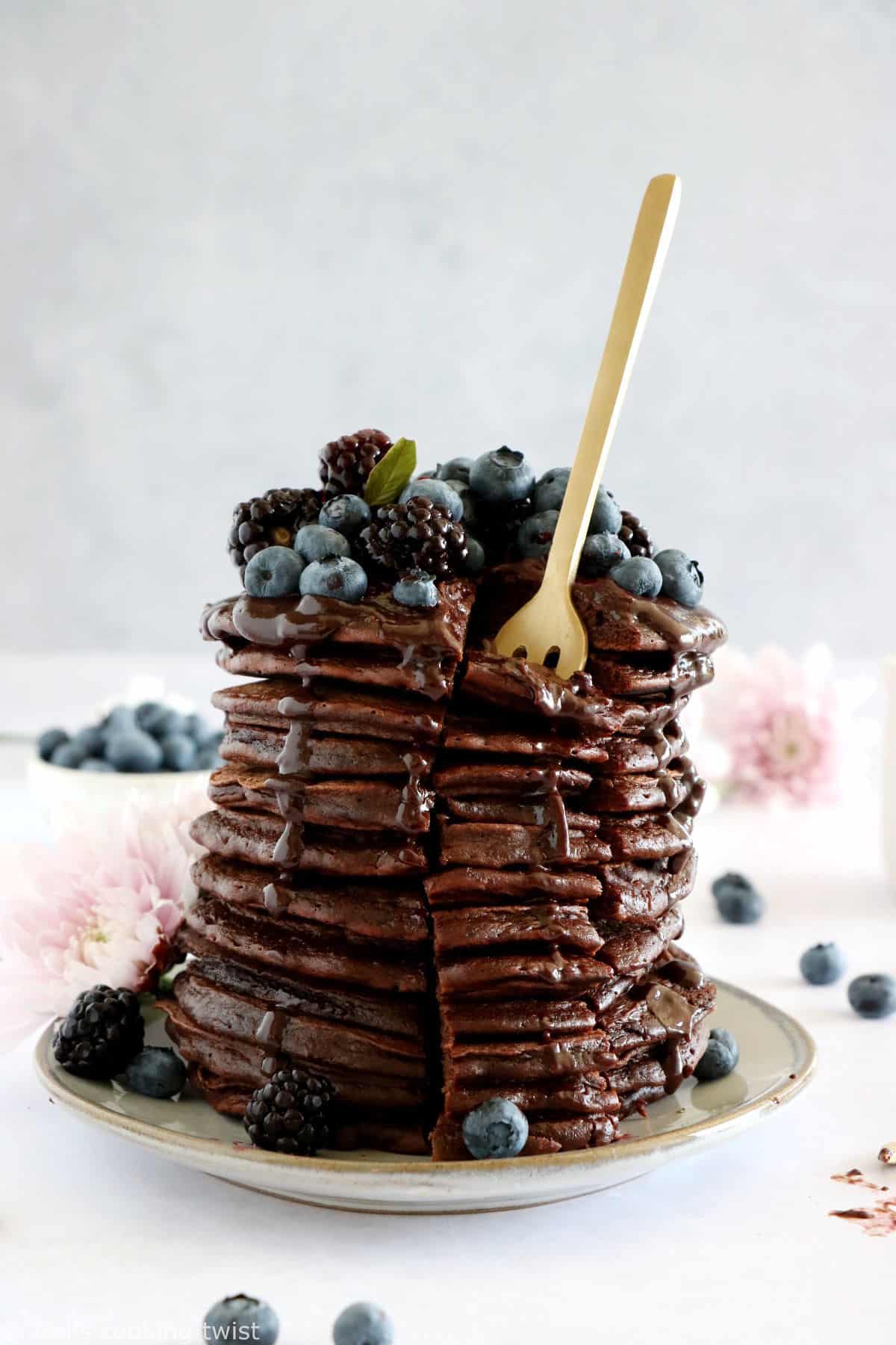Perfect chocolate pancakes are easy to make, fluffy, and topped with a rich hot chocolate sauce.