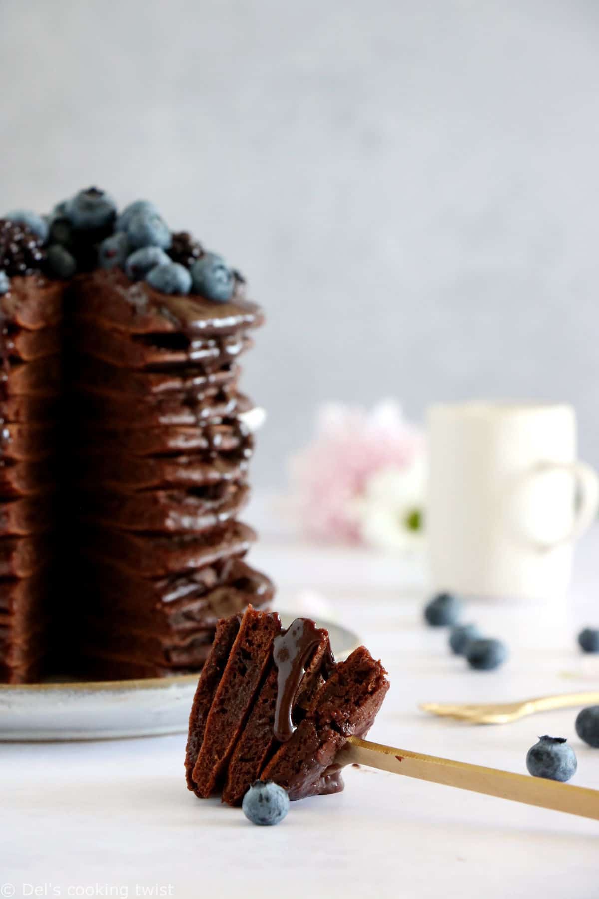 Perfect chocolate pancakes are easy to make, fluffy, and topped with a rich hot chocolate sauce.