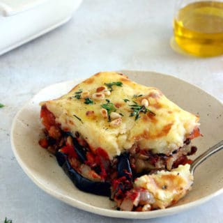 This vegetarian moussaka has some deep smoky flavors, with layers of eggplants, potatoes, spiced vegetarian meat, and a creamy bechamel sauce.