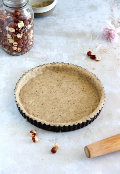 Hazelnut pie crust is a sweet shortcrust pastry prepared with ground hazelnuts. The dough comes together easily with just a few ingredients and has a subtle nutty flavor.