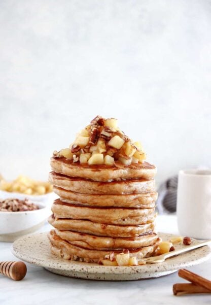 Healthy apple pancakes are prepared with shredded apples and a mix of whole wheat flour and almond flour to make them more nutritious.