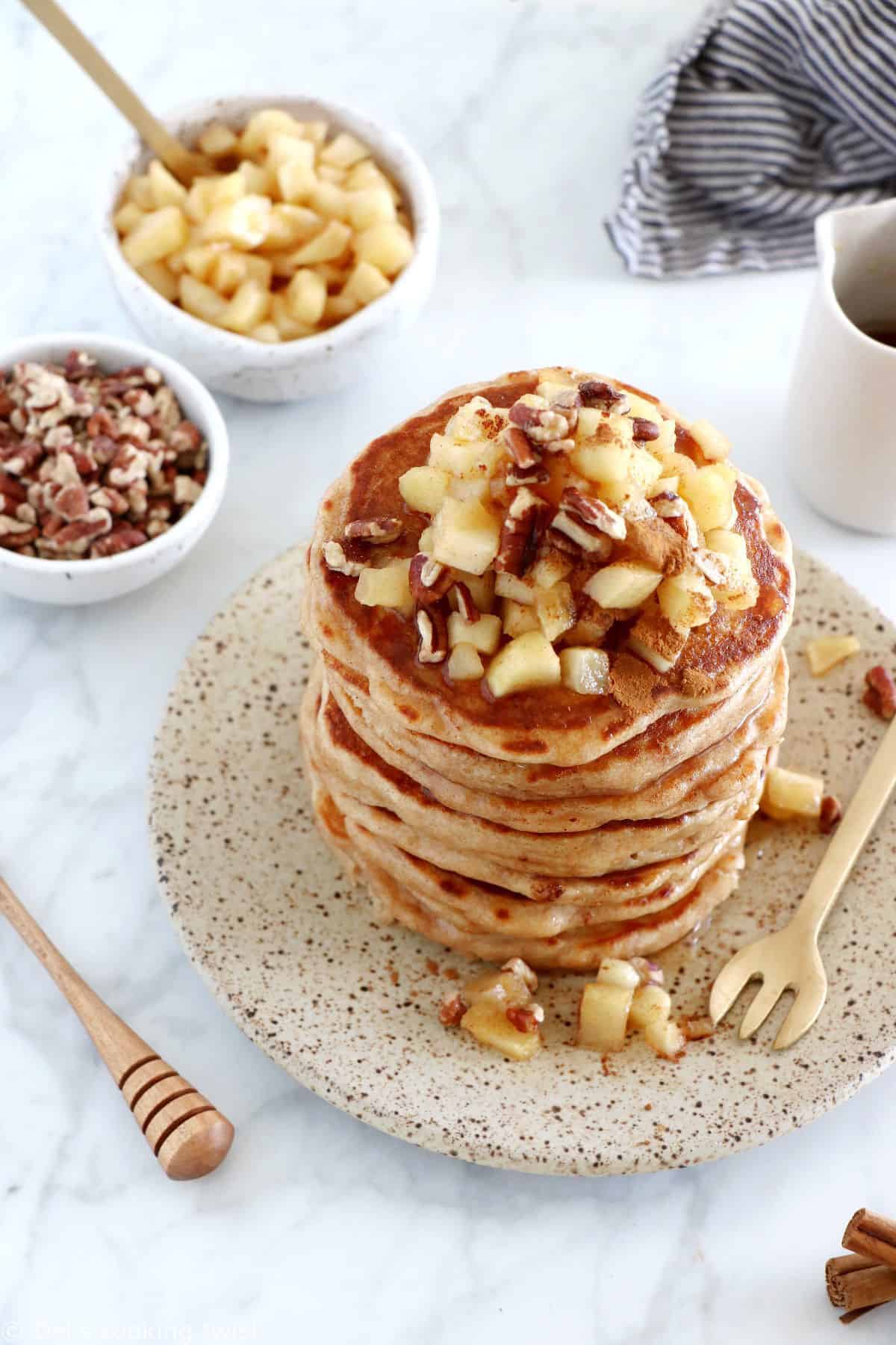 Healthy apple pancakes are prepared with shredded apples and a mix of whole wheat flour and almond flour to make them more nutritious.