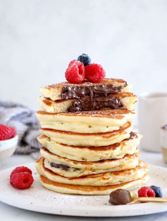 Nutella-stuffed pancakes are a dream come true! Imagine a stack of pillowy soft, fluffy pancakes, oozing with a warm chocolate center.