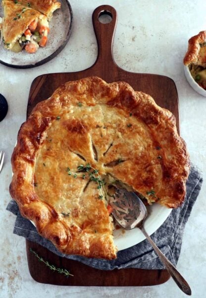 A rustic vegetarian pot pie loaded with hearty veggies coated in a creamy gravy, and tucked in between two crunchy flaky pie crusts.